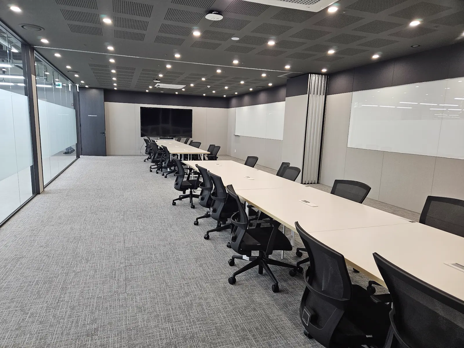 GPUN conference room with long tables and a display